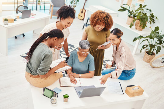 Business women, meeting and computer planning, design teamwork or brainstorming for office website ideas. Group of women in collaboration and notebook or writing goals for branding with laptop above