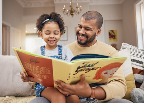 Father, daughter and book on sofa with smile, bonding and love in storytelling in living room together. Happiness, man and child reading story on couch for fantasy, learning and education in home fun
