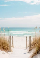 Tuinposter Afdaling naar het strand Wooden boardwalk leading to a sandy beach with tall grasses. The ocean and the sky are light blue with white waves and clouds. The image has a peaceful and serene mood. 