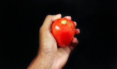 a tomato held by a man