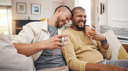 Laughing, relax and a gay couple on the sofa with coffee, conversation or love in a house. Happy,...