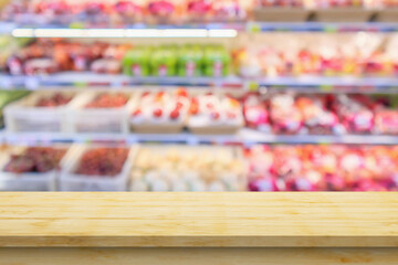Empty wood table top with supermarket blurred background for product display