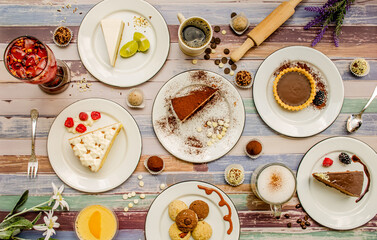 Dessert table with all kinds sweet snacks on wood background. table. Top view, flat lay