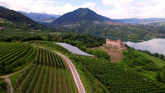 most famous and beautiful medieval castles of northern Italy. scenic Cles castel- in Trentino , province of Trento. lake Santa Giustina. Val di Non  apple valley. aerial drone view