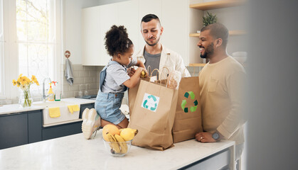 Recycling, blended family or adoption with a daughter and gay couple in the home kitchen for sustainability. LGBT, eco friendly or waste with a girl and parents unpacking bananas from a grocery bag