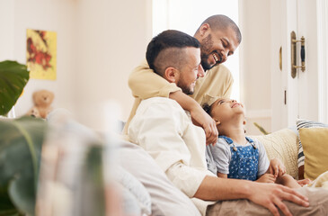 Gay, happy family and a child hug on a home sofa with love, care and safety in a lounge. Lgbtq men,...