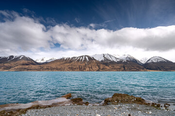Scenic sunrise view of Lake Pukaki east bank, with their mesmerizing turquoise hue and reflect the majestic snow-capped Southern Alps. Perfect for travel brochures, and nature magazines.
