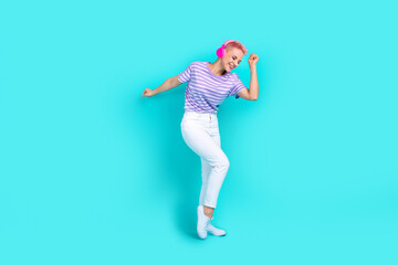 Full size body cadre of carefree party meloman woman pink dyed hair dancing enjoy air pods apple isolated on aquamarine color background