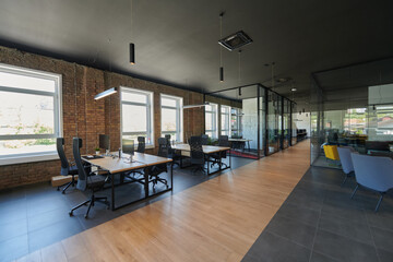 In a setting of modern, glass-walled business startup offices, the open, airy workspace reflects a contemporary and innovative ambiance, promising a dynamic environment for entrepreneurial growth