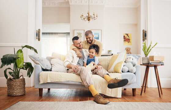 Gay, Happy Family And A Child On A Sofa At Home With Love, Care And Safety In A Lounge. Lgbtq Men, Adoption And Parents With A Foster Girl Kid Together On A Couch For Happiness, Bonding And To Relax