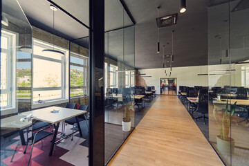 In a setting of modern, glass-walled business startup offices, the open, airy workspace reflects a contemporary and innovative ambiance, promising a dynamic environment for entrepreneurial growth