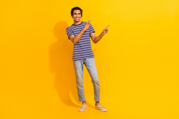 Fototapeta na wymiar Full body portrait of cool positive man look indicate fingers empty space proposition isolated on yellow color background