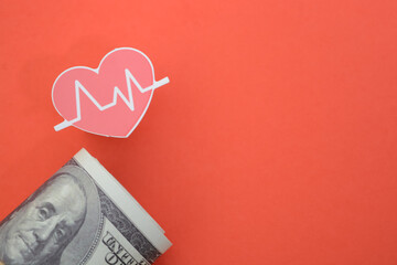 Heart beat and money banknotes. symbolizing the concept of tracking health expenses or medical costs