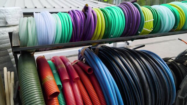 Colored garden hoses are sold in the store.