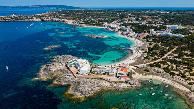 Aerial of the turquoise waters and white sand beach of the Pujols beach, Formentera, Balearic Islands, Spain, Mediterranean