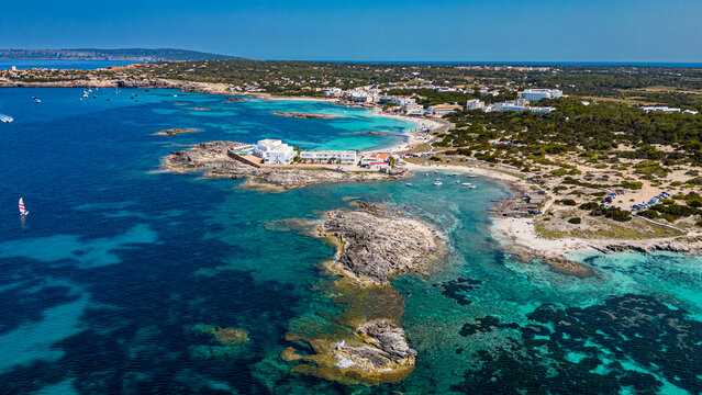 Aerial of the turquoise waters and white sand beach of the Pujols beach, Formentera, Balearic Islands, Spain, Mediterranean