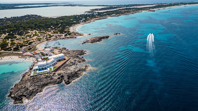 Aerial of the turquoise waters and white sand beach of the Pujols beach, Formentera, Balearic Islands, Spain, Mediterranean