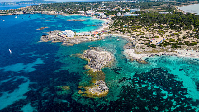 Aerial of the turquoise waters and white sand beach of the Pujols beach, Formentera, Balearic Islands, Spain, Mediterranean