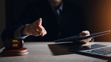 Business and lawyers discussing contract papers with brass scale on desk in office. Law, legal services, advice, justice and law concept picture with film grain effect
