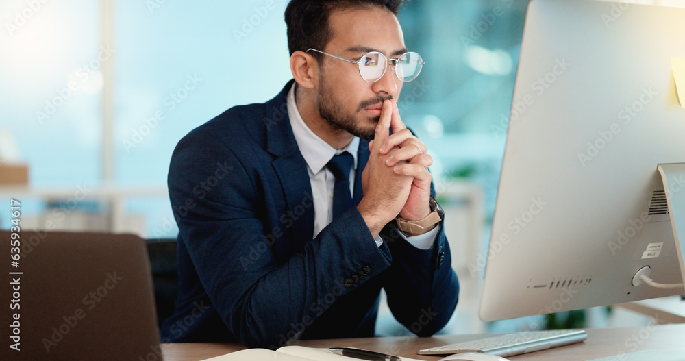 Poster Thinking IT manager working on a desktop computer and laptop in a modern office. Information Technology software engineer analyzing data management system. Thoughtful analyst looking for a solution