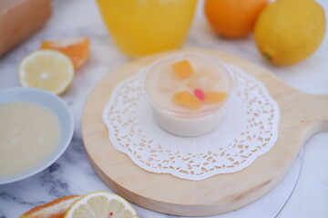 Yogurt with lemon, orange and grapefruit on white background