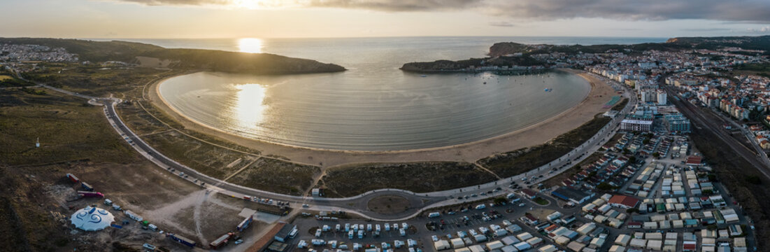 Aerial drone panoramic view at sunset of Sao Martinho do Porto bay, shaped like a scallop with calm waters and fine white sand, Oeste, Portugal