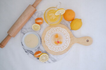 Yogurt with lemon, orange and grapefruit on white background