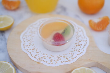 Fruit jelly with orange juice, lemon and kiwi on the table
