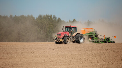 Modern tractor sowing directly into the ground with equipment using GPS for precision farming in...