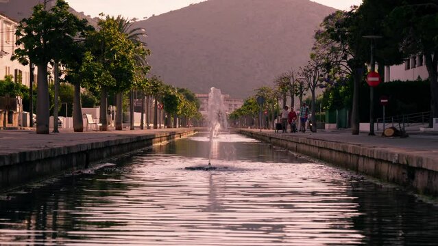 Canal with fountain overlooking the mountains