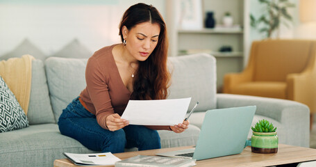 Fototapeta premium Woman, paper and laptop in living room on sofa working on project, assignment or task for college or business. Student, girl and home to study, for test or exam at university with handheld movement