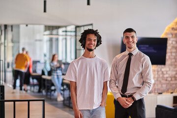 A group of colleagues, including an African American businessman and a young leader in a shirt and...