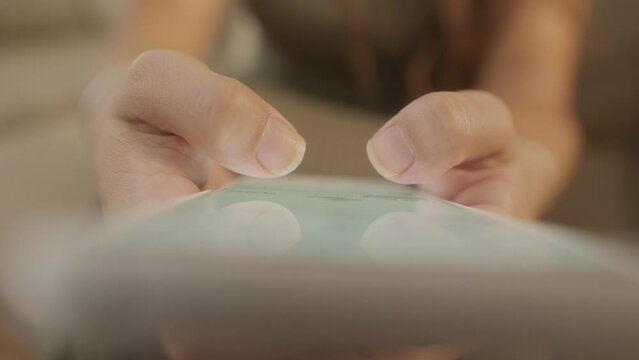 detail of fingers typing. Close up of female hands checking social media app 