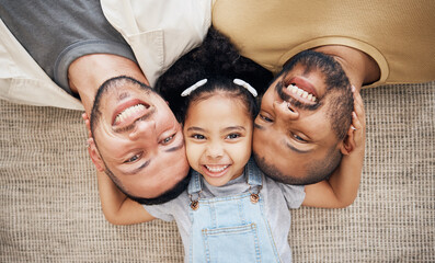 Portrait, gay dad and blended family with a girl lying together on the floor of the home for...