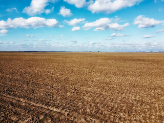 Beautiful blue sky over farm fields on a sunny day, aerial view. Landscape. - obrazy, fototapety, plakaty