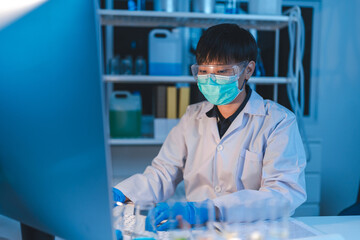 woman scientist working at laboratory overtime late at night looking to side, confident research...