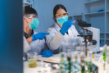woman scientist working at laboratory overtime late at night looking to side, confident research...