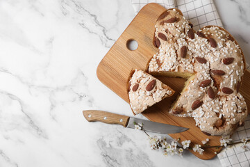 Delicious Italian Easter dove cake (traditional Colomba di Pasqua), knife and branch with beautiful...