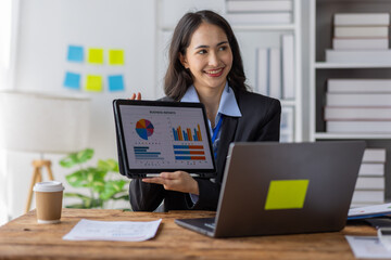 Businesswoman working at office with documents on his desk, doing planning analyzing the financial report, business plan investment, finance analysis concept	