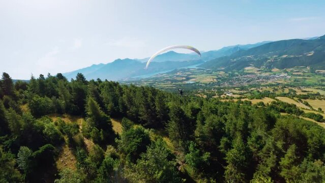 Explore paragliding in the French Hautes-Alpes, near Lake Serre-Pon&ccedil;on, during summer. Captivating aerial view captured by drone
