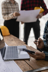 A team of engineers and architects, men and women working together, discussing design, planning,...