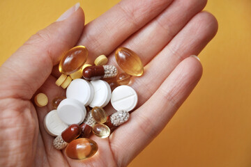 capsules, tablets, vitamins in a person's hand