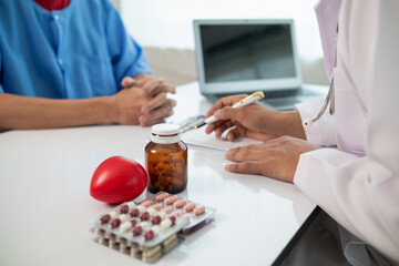 A heart patient visits a doctor for advice on health care and medication to treat heart disease...