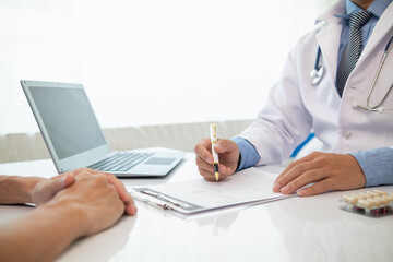 A heart patient visits a doctor for advice on health care and medication to treat heart disease symptoms after the medical team has diagnosed and examined the patient for heart abnormalities.