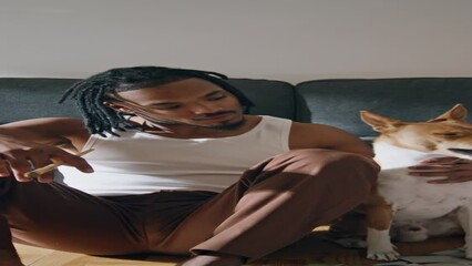 Positive man posing pet home zoom on vertical. African american guy embrace dog - Powered by Adobe