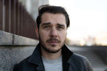 a sad European middle-aged man in front of a building