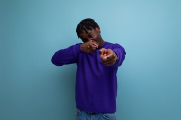 positive black american young guy with dreadlocks smiling and joking