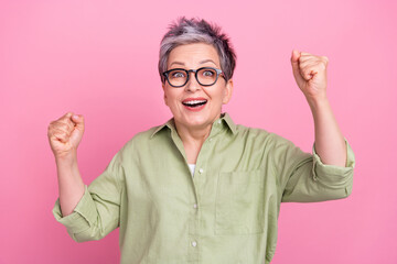 Portrait of positive satisfied delighted person raise fists attainment accomplishment isolated on...