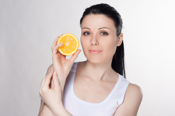 Young happy woman with oranges on isolated background. 
