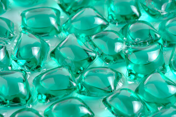 Background lot of capsules for washing green on light background.